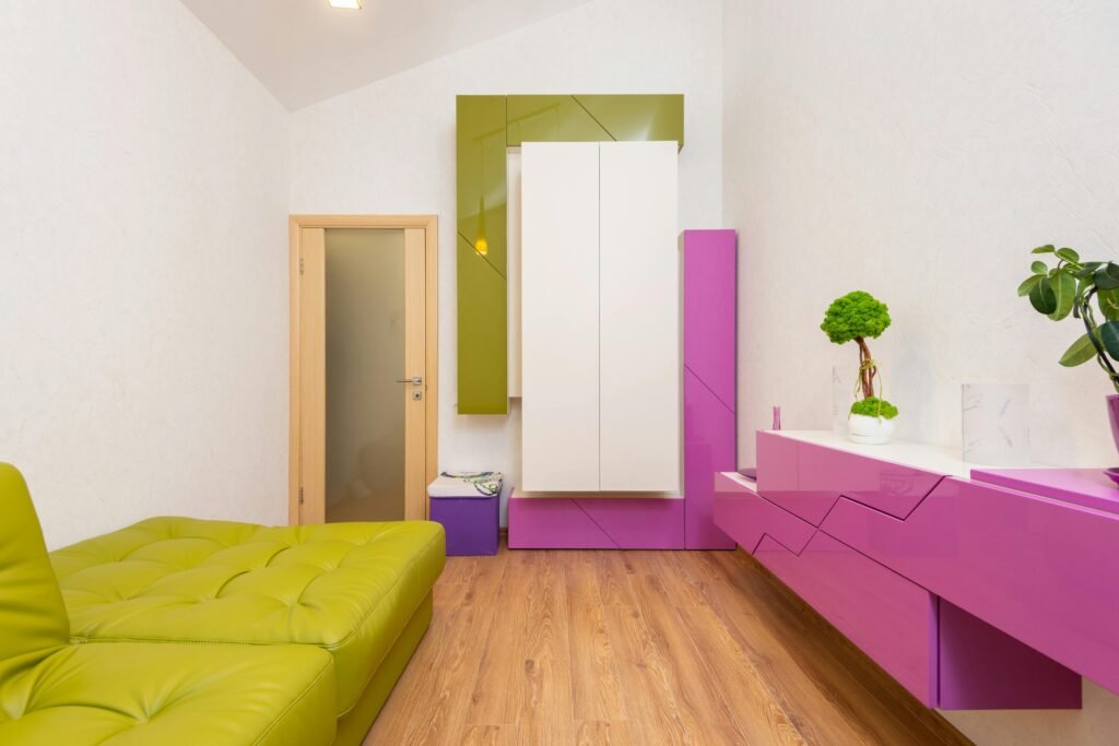 Stylish contemporary room with bold pink and green furniture and minimalist decor.
