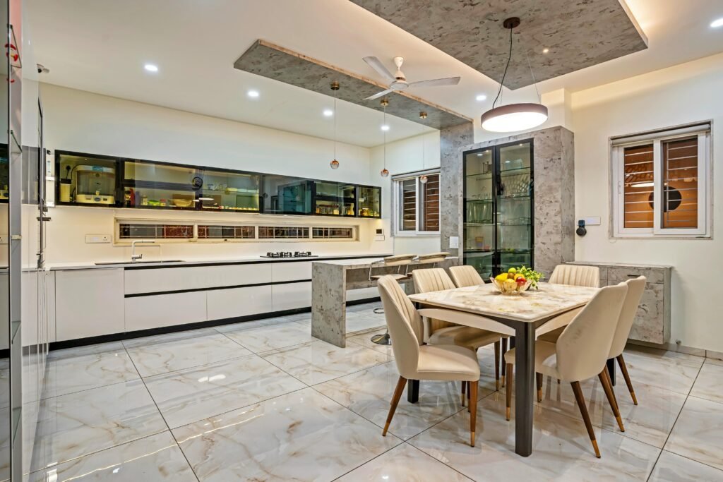 Spacious and elegant modern kitchen interior featuring a dining area with stylish furniture.